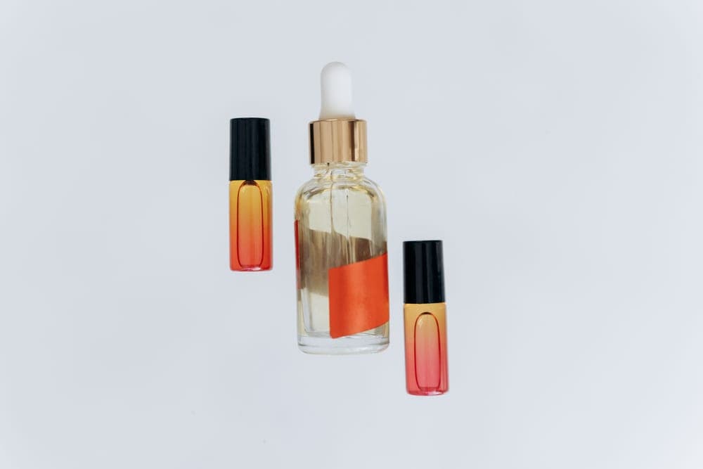 A dropper bottle of oil on a neutral surface