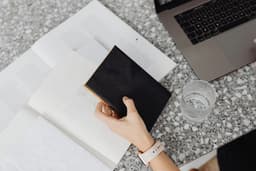 A desk with skincare products and notes